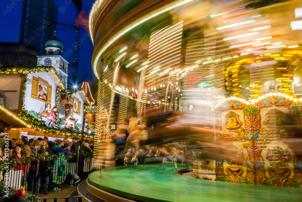 Obraz premium Christmas carousel in motion at christmas market at Birmingham, UK