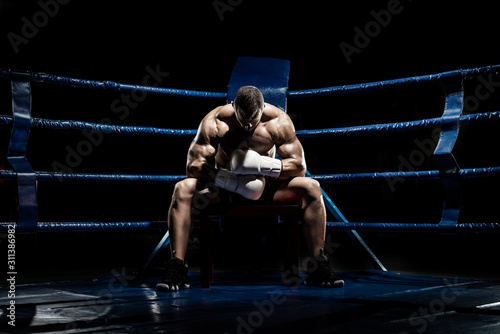 punching boxer on boxing ring photo