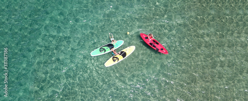 Aerial drone top view photo of friends practising canoe in tropical exotic turquoise sandy beach © aerial-drone