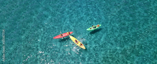 Aerial drone top view photo of friends practising canoe in tropical exotic turquoise sandy beach
