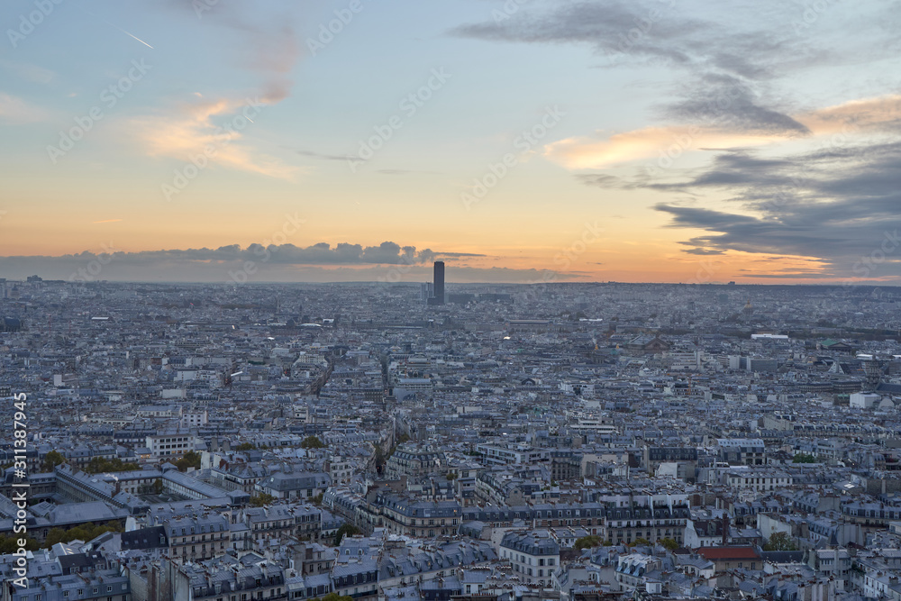 Panoramic cityscape with a skyscraper in Paris at sunset, France.