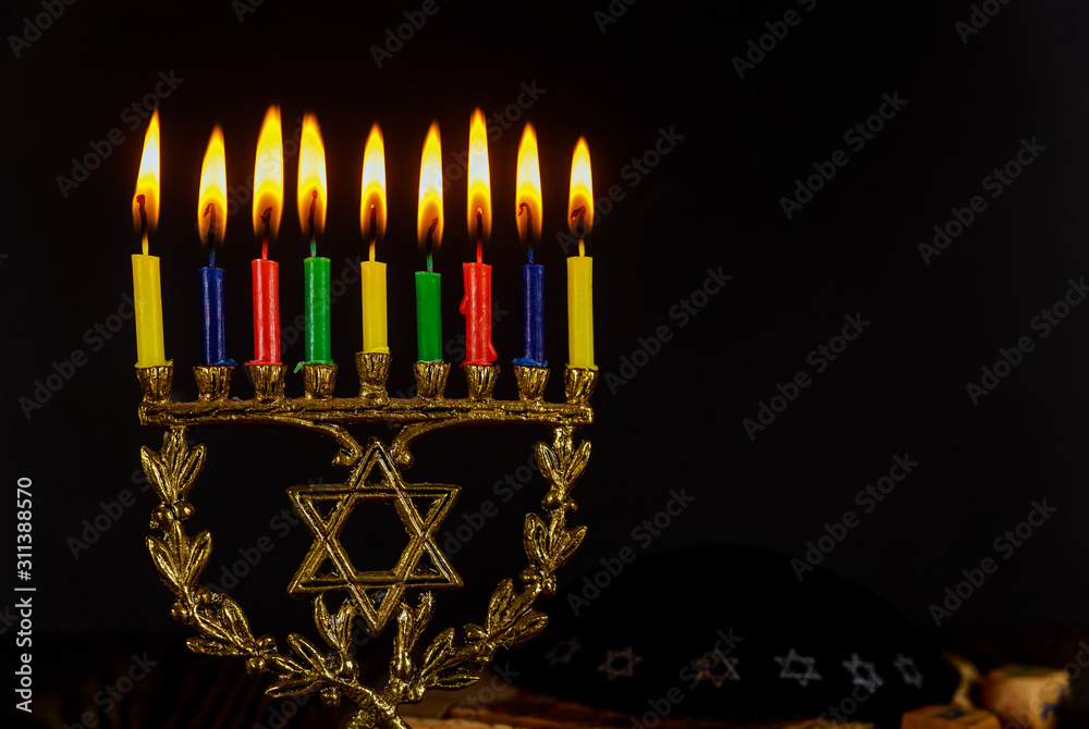 Fototapeta premium Menorah with burning candles for Hanukkah on sparkle black background with jewish holiday.