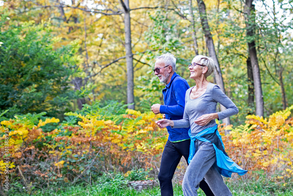 Mature couple man and woman jogging in the park Mature couple man and woman jogging in the park