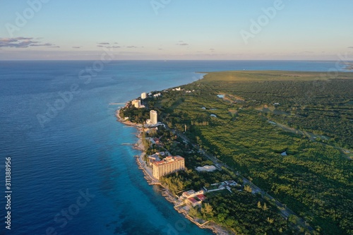 Coast line of Cozumel island with beach front hotels, tropical forest and turquoise blue Caribbean Sea © Luis