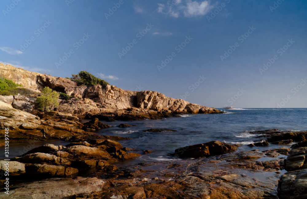 Afternoon sea view, rocks, boat in the island	