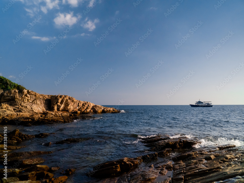 Afternoon sea view, rocks, boat in the island	
