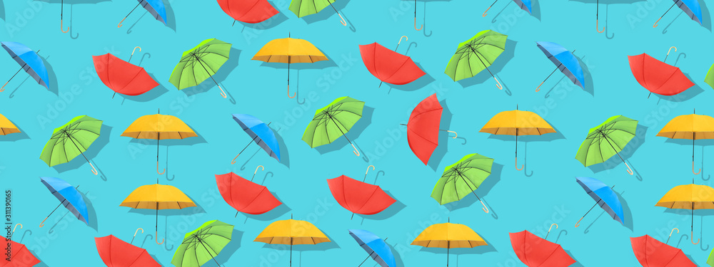 Multi-colored umbrellas pattern on blue background. Multi-colored umbrellas pattern on blue background.
