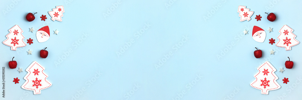 New Year and Christmas banner. Frame frome red and white christmas toys on blue background. Top view, flat lay, copy space New Year and Christmas banner. Frame frome red and white christmas toys on blue background. Top view, flat lay, copy space