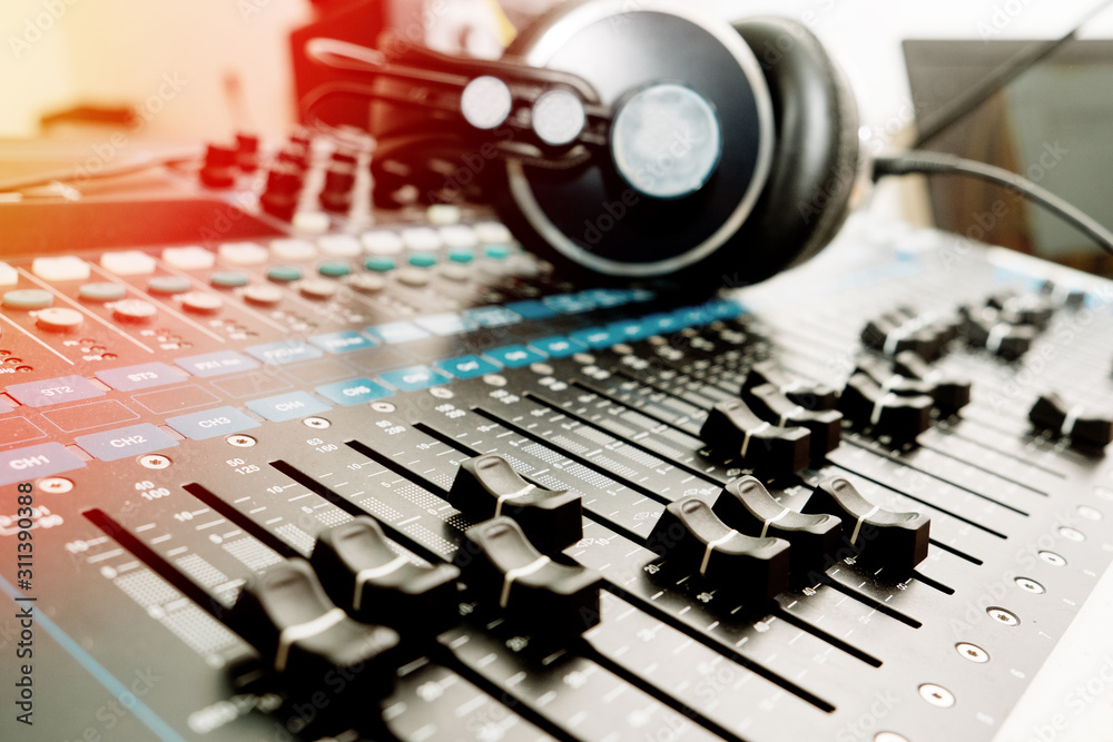 Part of an audio sound mixer with buttons and sliders Part of an audio sound mixer with buttons and sliders