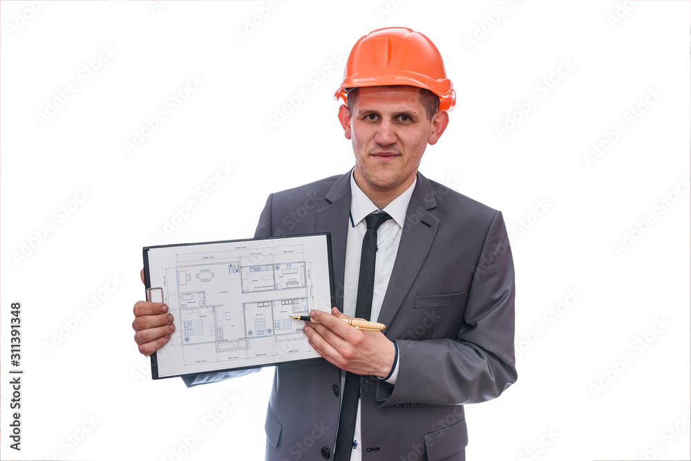 Man in suit and helmet pointing at house plan Man in suit and helmet pointing at house plan