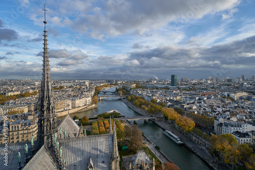 Panoramic view to the Paris and river Seine from the roof of Notre Dame cathedral, France. Cloudy weather. Autumn. 