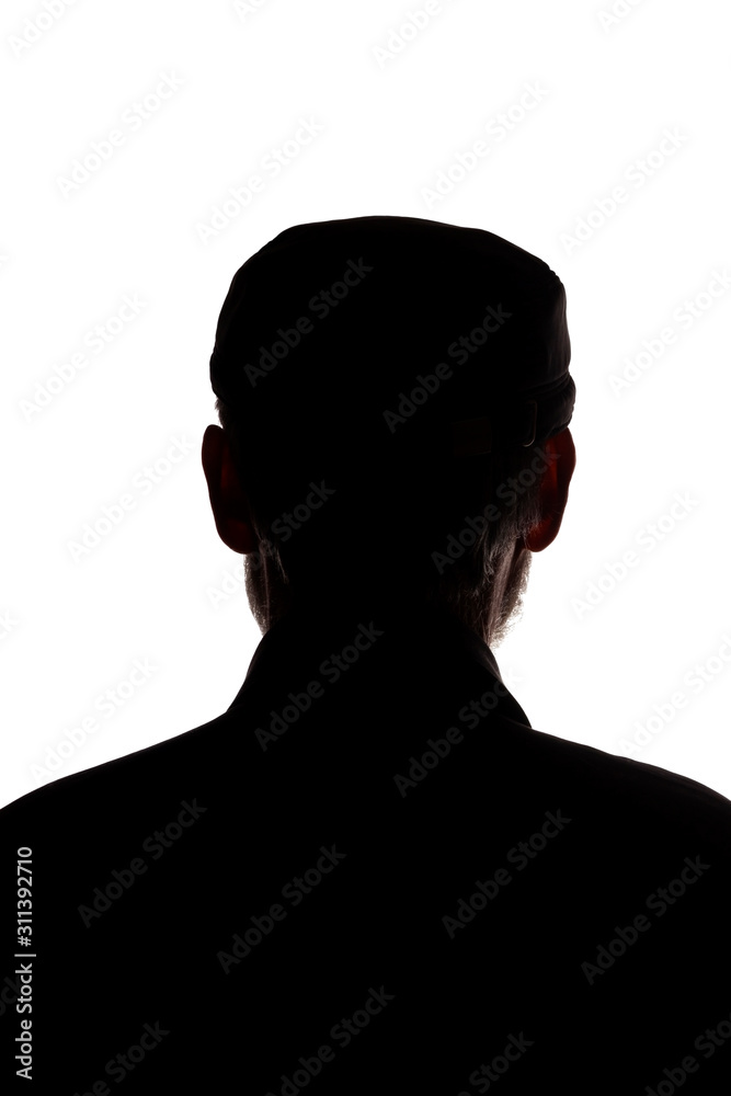 Old man in peaked cap, rear view - dark close-up silhouette Old man in peaked cap, rear view - dark close-up silhouette