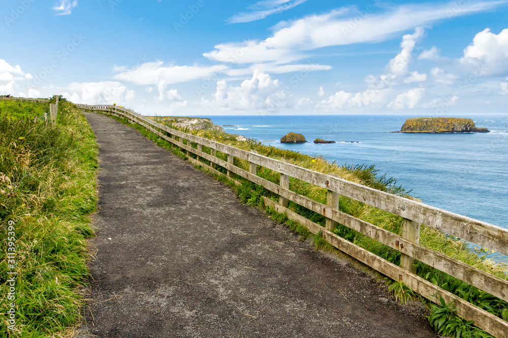 Cliffs of Carrick-a-rede rope bridge in Ballintoy, Co. Antrim. Landscape of Northern Ireland.Traveling through the Causeway Coastal Route.