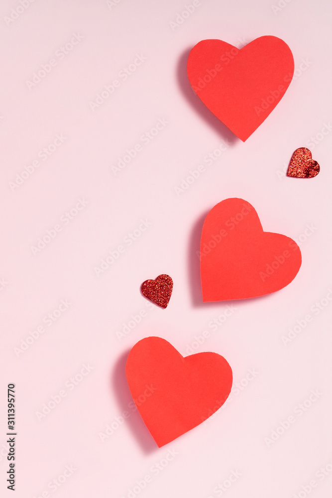 Valentine's day frame composition. Red hearts on pastel pink background. Top view, flat lay, copy space