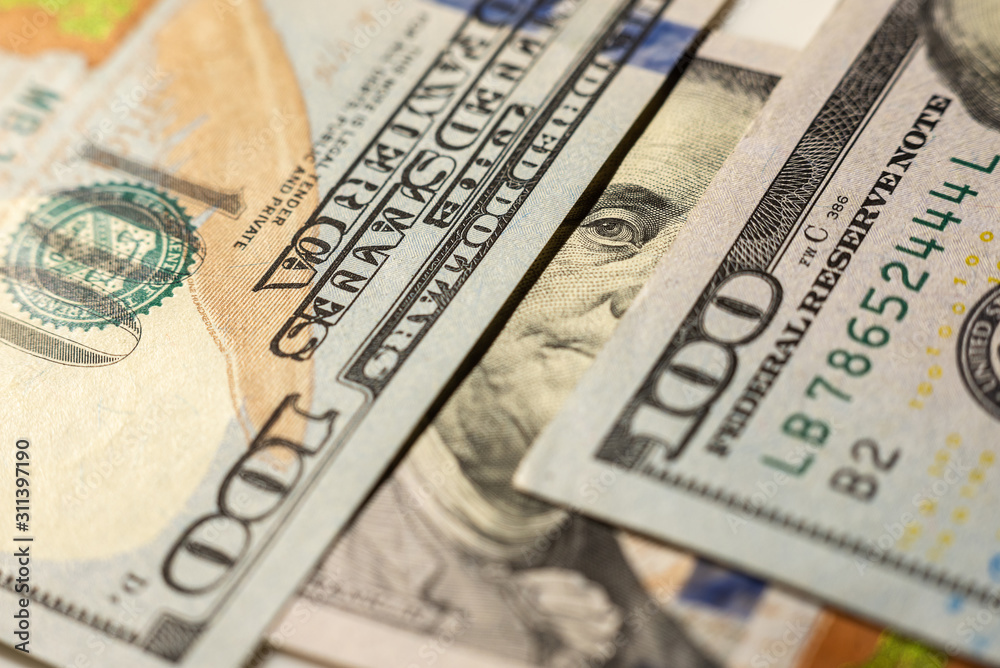 Benjamin Franklin eyes from hundred-dollar bill. The face of Benjamin Franklin on the hundred dollar banknote, backgrounds, close-up.