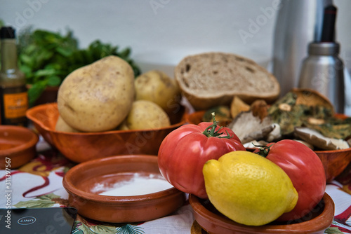 Still life of organic and fresh natural vegetables. Potatoes, tomatoes, lemon, bread, harina, mushrooms, vegetables