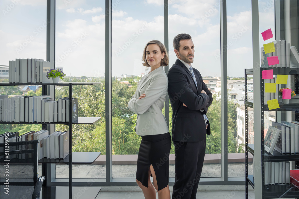 Business men and business women are standing with their arms crossed back Business men and business women are standing with their arms crossed back