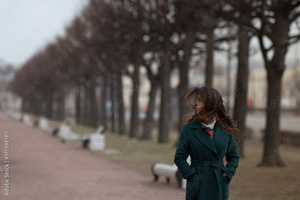 Brunette woman walking in a windy day, windy fluffing hair