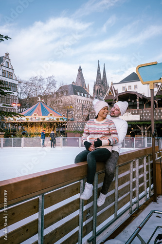 young couple visit the Christmas market in Cologne Germany during a city trip, men and woman at Christmas market photo