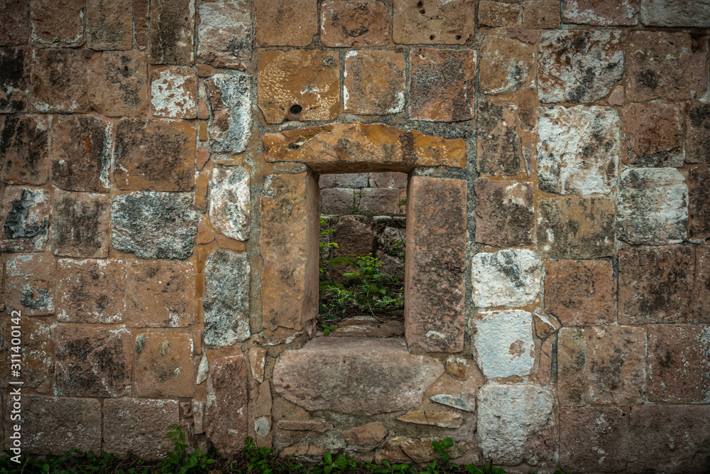 old window on mayan wall old window on mayan wall