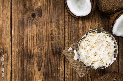 Some healthy Coconut Chips (selective focus; close-up shot)