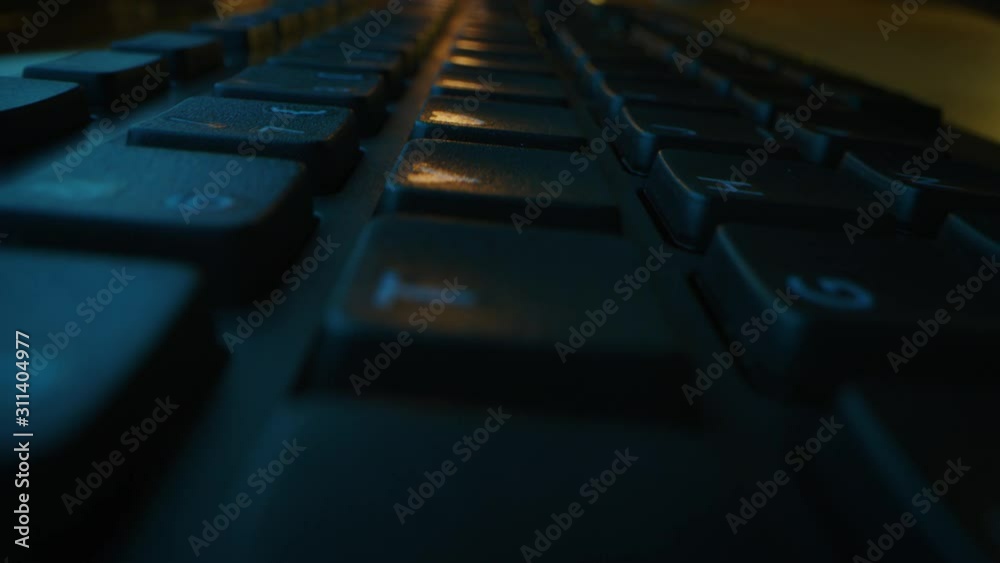 Close-up Moving Macro Shot: Person Typing on the Computer Keyboard. Working, Writing Emails, Using Internet. Dark and Green Colors Close-up Moving Macro Shot: Person Typing on the Computer Keyboard. Working, Writing Emails, Using Internet. Dark and Green Colors