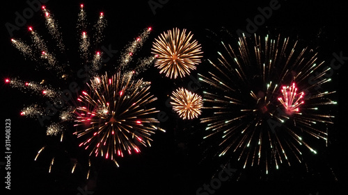 Colorful holiday fireworks on the black sky background