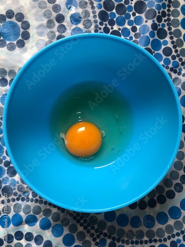Egg yolk on a blue bowl