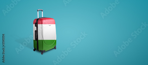 Travel suitcase with the flag of Italy. Holiday destination, panoramic mock-up over blue background
