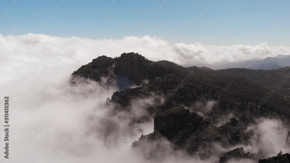 Flying drone above the clouds in the mountains, a beautiful panoramic view from a bird's eye view, Pico de las Nieves, Gran Canaria