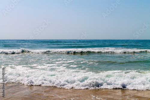 Waves at the shore shot at bright sunny day