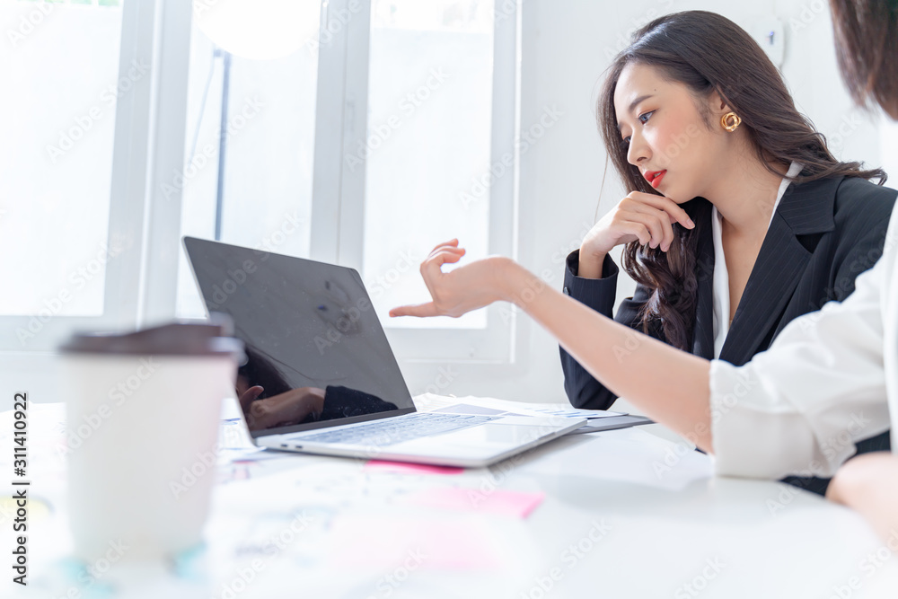 Successful and Team work process concept.Two women with laptop in open space office. Sun glare and Film effect effect.copy space. Successful and Team work process concept.Two women with laptop in open space office. Sun glare and Film effect effect.copy space.