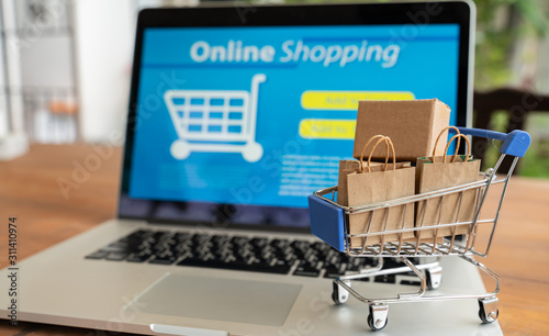 Online shopping and iot(internet of things) concept.Boxes in a trolley on a laptop. Ideas for online shopping,online shopping is consumers to directly buy goods from a seller over the internet.