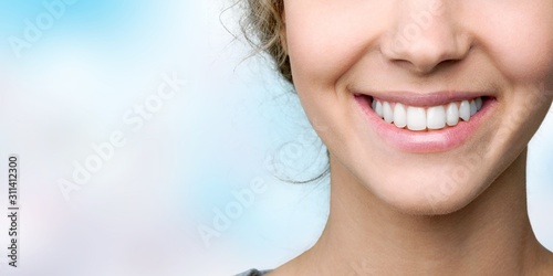 Beautiful smile of young woman with healthy white teeth