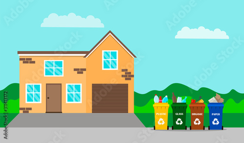 Garbage containers in front of the house. Recycling garbage in front of a house on the street. Household waste sorting management concept. Lifestyle and environmental care.