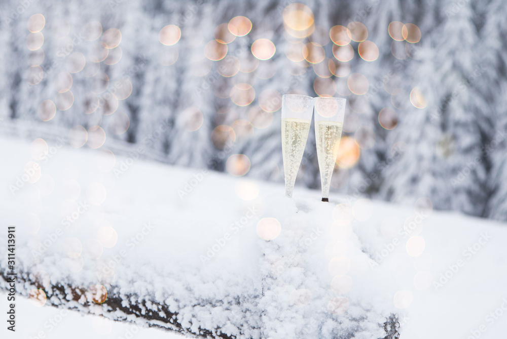 Champagne glasses in winter wonderland snow