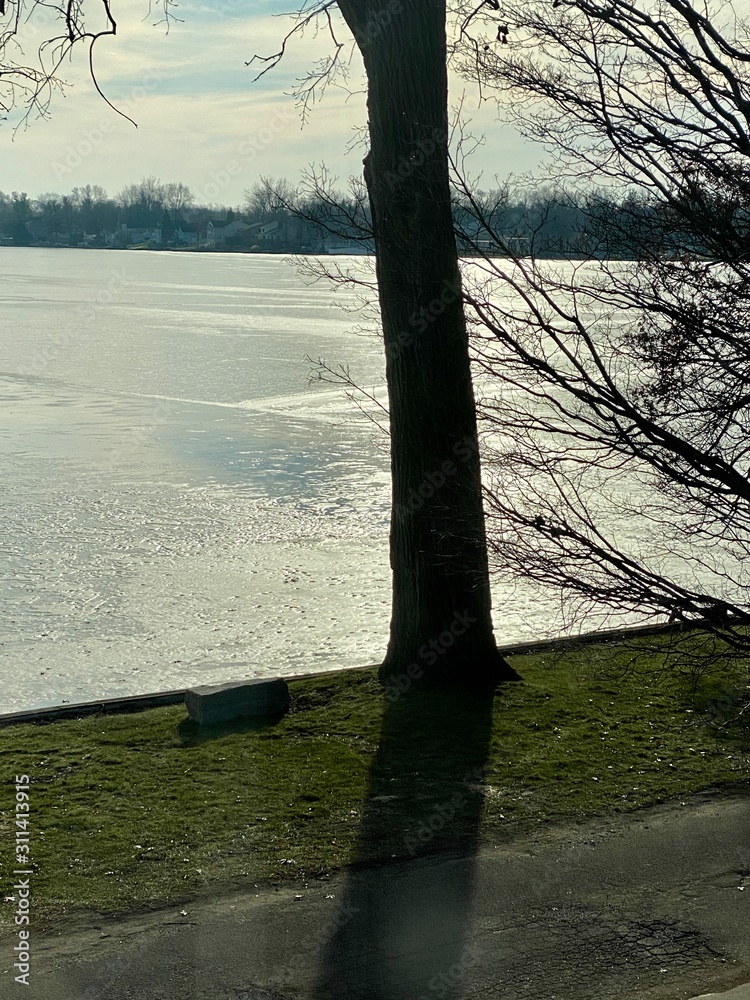 Winter solstice sun glistening on lake in winter