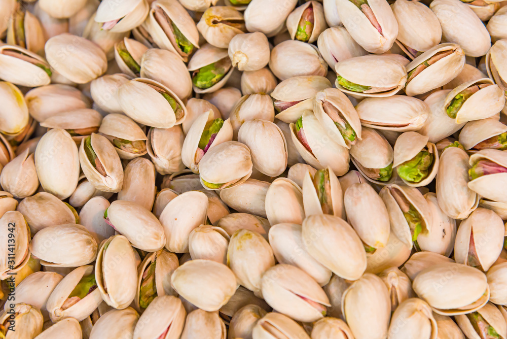 Roasted and salted pistachios in shell texture, background