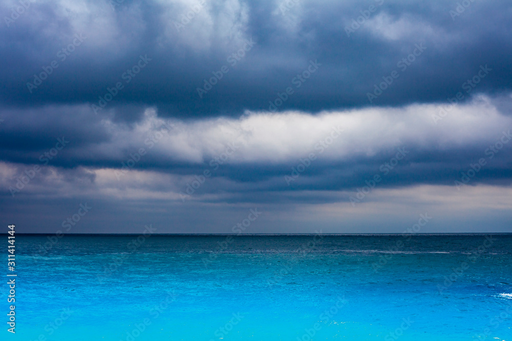 Turquoise sea water with storm dramatic sky i