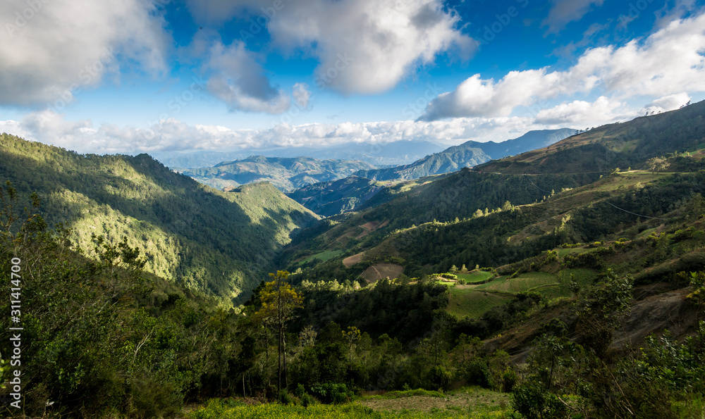 dramatic landscape high in the caribean mountains of the dominican republic with clouds and blue sky.