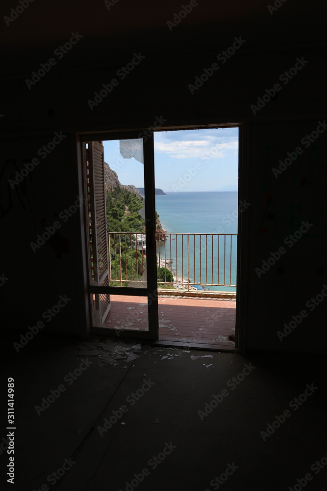 View to Mediterranean sea from abandoned hotel door