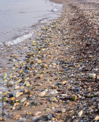 Stones on the beach. Colorful stones and waves.