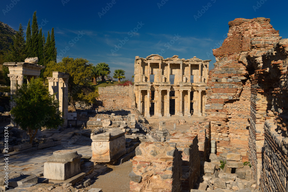 Hadrians Gate pillars and Library of Celsus from Latrine ruins at ancient Ephesus Turkey