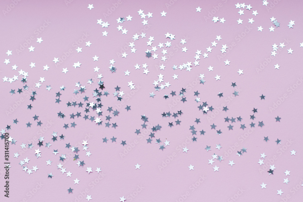 Silver stars shine on a bright pink background. Festive holiday bright background. Silver stars shine on a bright pink background. Festive holiday bright background.