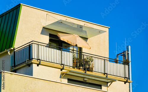 Apartment in residential building exterior. Housing structure at blue modern house of Europe. Rental home in city district on summer. Architecture for business property investment, Leibnitz Austria. © Roman Babakin