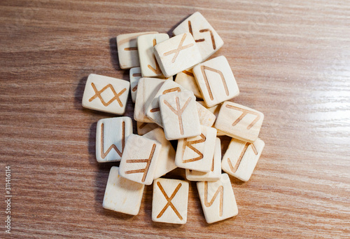 Stack of wooden fortune-telling runes on a wooden background. View from above. Fortune. Future.Selective focus.