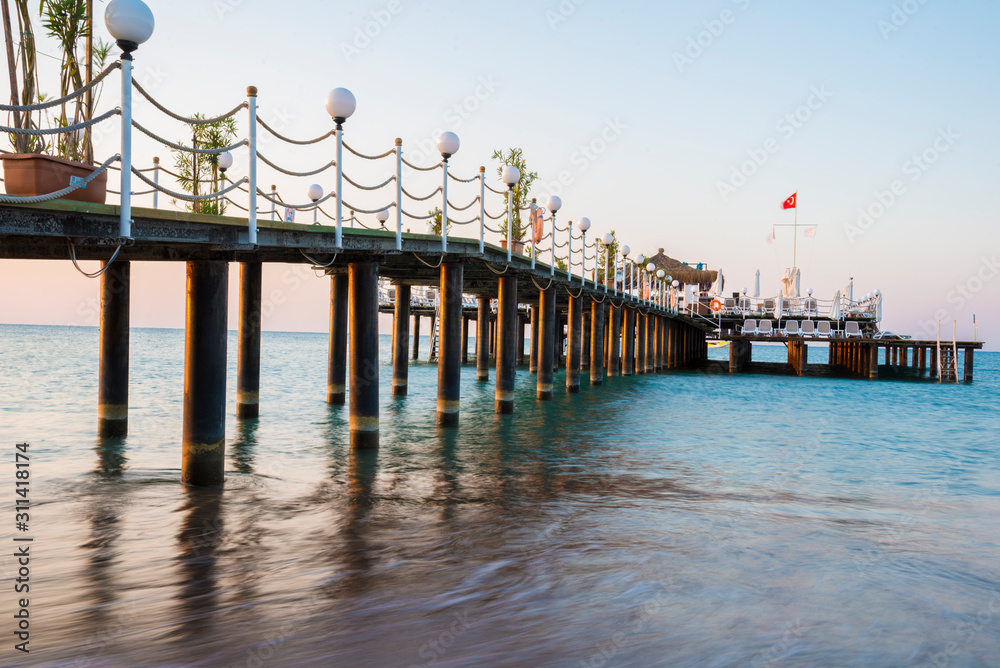Empty wooden pier in the summer resort with festivity decoration