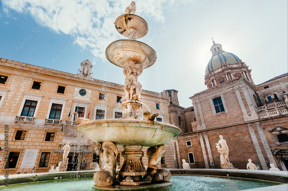 Marble sculptures in center of 16th century Praetorian Fountain in historical sicilian city, Palermo.
