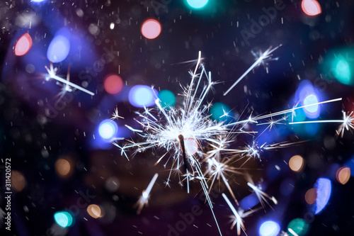 Burning sparkler in hands c...