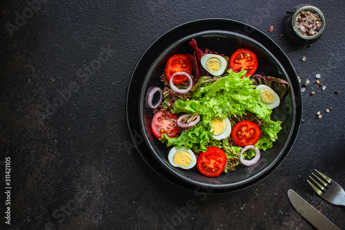  healthy salad quail eggs (vegetables, tomato, lettuce and other ingredients) menu concept. food background. top view. copy space